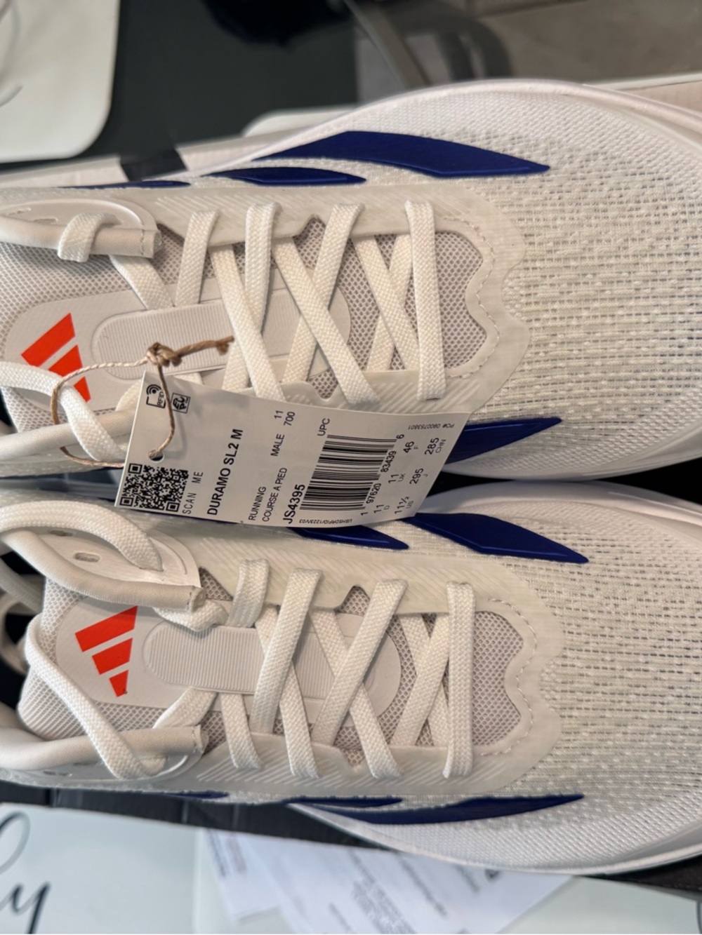 adidas Men’s White Athletic Shoes with Blue and Orange Accents